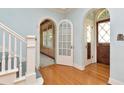 Inviting foyer showcasing hardwood floors, arched doorways, and a staircase with white banisters at 535 22Nd N Ave, St Petersburg, FL 33704