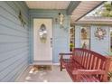 Inviting front entrance featuring a decorative glass door and cozy bench seating at 5633 99Th N Ter, Pinellas Park, FL 33782