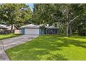 Beautiful home with lush green lawn and mature trees providing ample shade at 5633 99Th N Ter, Pinellas Park, FL 33782