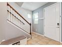 Inviting entryway featuring a staircase, tiled floor, and a white front door at 5831 Caldera Ridge Dr, Lithia, FL 33547