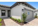 Charming single-story home boasts a paved walkway, landscaped yard and neutral-colored stucco exterior at 6133 Wire Grass Ct, Nokomis, FL 34275