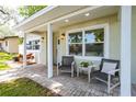 View of the front porch with seating, showing the home's curb appeal and landscaping at 615 6Th N Ave, Safety Harbor, FL 34695