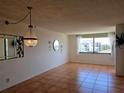 Bright living room with tile flooring, decorative chandelier, and a large window with a view at 6218 Palma Del Mar S Blvd # 503, St Petersburg, FL 33715