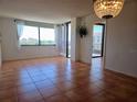 Spacious living room features tile floors, large windows, and access to the balcony at 6218 Palma Del Mar S Blvd # 503, St Petersburg, FL 33715