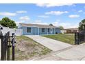 Charming single-story home featuring a well-maintained yard, fenced perimeter, and private driveway at 6417 Willow Wood Ln, Tampa, FL 33634
