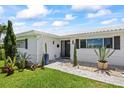 Inviting front entrance features a walkway, manicured landscaping, and a well-maintained exterior at 7892 10Th S Ave, St Petersburg, FL 33707