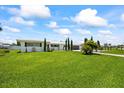 Charming single-story home featuring a well-maintained lawn, mature trees, and a welcoming facade at 7892 10Th S Ave, St Petersburg, FL 33707