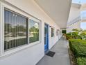 Exterior view of the property shows the facade, front door, walkway and lush landscaping at 8080 112Th St # 108, Seminole, FL 33772