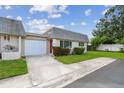 Charming home featuring a well-manicured lawn, red door, and attached garage on a sunny day at 8447 Orleans N, Pinellas Park, FL 33781