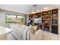 Cozy living room with built-in shelving and desk area providing ample storage and workspace at 8515 Macoma Ne Dr, St Petersburg, FL 33702