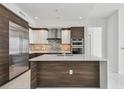 Well-equipped kitchen with stainless steel appliances, a large island, and sleek, two-tone cabinetry at 100 1St N Ave # 2304, St Petersburg, FL 33701