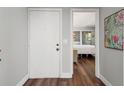 View of the entryway revealing the bedroom with mirrored closet doors and hardwood floors at 1011 S Moody Ave # 11, Tampa, FL 33629
