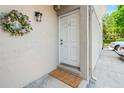 Exterior view of the front door with seasonal wreath and exterior lighting at 1011 S Moody Ave # 11, Tampa, FL 33629
