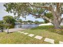 A serene backyard with a private dock and lush greenery leads to tranquil waterfront views at 10730 52Nd N Ave, St Petersburg, FL 33708