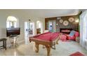 Spacious room features a billiards table, tile flooring, and archways leading to other living spaces at 10730 52Nd N Ave, St Petersburg, FL 33708