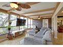Bright living room featuring large windows, tile floors, a comfortable sofa and a decorative accent wall at 10730 52Nd N Ave, St Petersburg, FL 33708