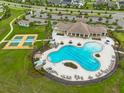 Aerial view of a community pool and recreation center with a large pool and tennis courts at 11035 Sage Canyon Dr, Riverview, FL 33578