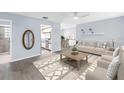 Bright living room showcasing neutral tones, modern furniture, and seamless flow to the kitchen at 11301 80Th Ave, Seminole, FL 33772