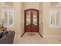 Grand front entrance with tile flooring and archways leading into the living room at 11430 Trotting Down Dr, Odessa, FL 33556