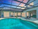 Relaxing screened-in pool area with lounge chairs, perfect for enjoying the outdoors in comfort at 12637 Tyler Run Ave, Odessa, FL 33556
