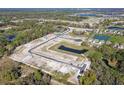 An aerial view of community construction with ponds, roads, and the foundations of homes at 12801 Castle Oaks Dr, Hudson, FL 34669