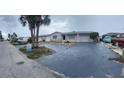 Charming single Gathering home featuring a spacious driveway and lush palm trees in a waterfront community at 13605 Stacey Dr, Hudson, FL 34667
