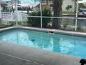Backyard featuring a refreshing screened-in pool with clean, clear water, perfect for outdoor relaxation at 13605 Stacey Dr, Hudson, FL 34667