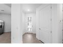 Bright hallway with a glass paneled front door, leading to other parts of the home at 14317 Eagle Branch Dr, Nokomis, FL 34275