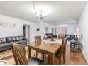 Open concept living room with dining room has hardwood floors and neutral paint tones at 14820 Rue De Bayonne # 301, Clearwater, FL 33762