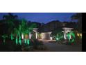 Beautiful two-story home with landscape lighting enhancing the curb appeal at twilight at 18434 Eastwyck Dr, Tampa, FL 33647