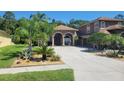 Charming home with an arched entry, desert landscaping and a long, cracked driveway at 18434 Eastwyck Dr, Tampa, FL 33647