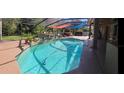 Sparkling pool with rock waterfall feature and screened enclosure, perfect for outdoor enjoyment at 18434 Eastwyck Dr, Tampa, FL 33647