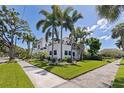 Expansive corner lot with lush landscaping, mature palms, and verdant lawn at 1920 Cherry Ne St, St Petersburg, FL 33704