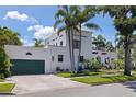 Two-story house showcasing a beautiful facade, a barrel tile roof, and an attached garage at 1920 Cherry Ne St, St Petersburg, FL 33704