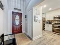 Inviting entryway featuring a wood-look floor, closet, and seamless access to the kitchen at 2254 Springrain Dr, Clearwater, FL 33763