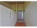 Welcoming entryway with tiled floor and decorative wall pieces, leading into the home's interior at 2609 Lancaster Dr, Sun City Center, FL 33573