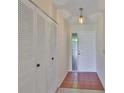 Bright hallway featuring a tiled floor, closet, and a front door with glass panels at 2609 Lancaster Dr, Sun City Center, FL 33573