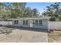 Inviting single-story home with a light gray exterior, updated windows and a well-manicured front yard at 2718 Boca Ciega N Dr, St Petersburg, FL 33710