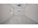 Spacious living room with tiled floor, ceiling fan, recessed lights and natural light from the windows at 2810 N 75Th St, Tampa, FL 33619
