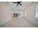 Bright and airy living room features a tiled floor with an open layout that flows into the modern kitchen at 2810 N 75Th St, Tampa, FL 33619