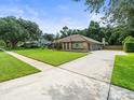 Suburban brick home with a lush lawn and a long driveway at 3305 Westmoreland Dr, Tampa, FL 33618