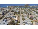 A picturesque aerial view of a charming neighborhood near the water, with a cozy home marked by an arrow at 434 77Th Ave, St Pete Beach, FL 33706