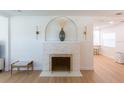 Bright living room featuring a stylish fireplace with modern decor and light hardwood floors at 434 77Th Ave, St Pete Beach, FL 33706