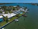 Waterfront property with lush landscaping, private dock, and swimming pool at 4545 Clearwater Harbor N Dr, Largo, FL 33770