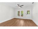 Minimalist bedroom featuring a ceiling fan, wood-look floors, and plenty of natural light at 459 Bell Ave, Brooksville, FL 34601