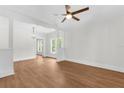 Bright, open-concept living room with white walls, wood floors, and ample natural light at 459 Bell Ave, Brooksville, FL 34601