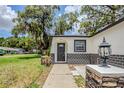 Inviting front entry featuring an arched doorway, stone accents, and modern lighting at 5847 Harrison St, New Port Richey, FL 34653