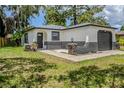 Charming home with an arched front door, stylish stone accents, and fresh landscaping at 5847 Harrison St, New Port Richey, FL 34653
