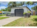Attached garage offers convenience and functionality, complemented by lush landscaping at 5847 Harrison St, New Port Richey, FL 34653