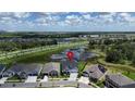 A beautiful aerial view of a home in a quiet neighborhood with nearby lakes and green spaces at 5971 Hidden Branch Dr, Apollo Beach, FL 33572